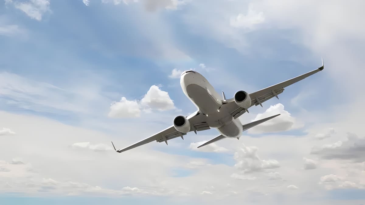 A airplane on take off with blue sky and clouds