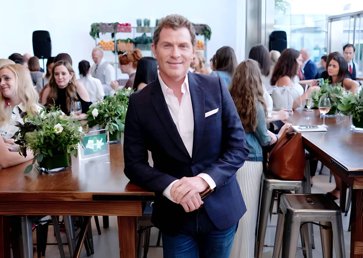 Bobby Flay posing in the middle of a restaurant