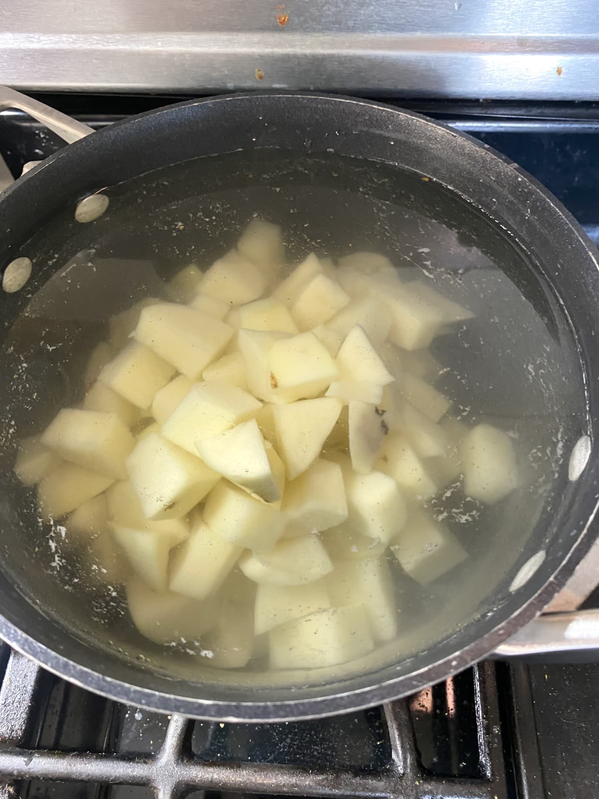 Small potato chunks boiling in a pot