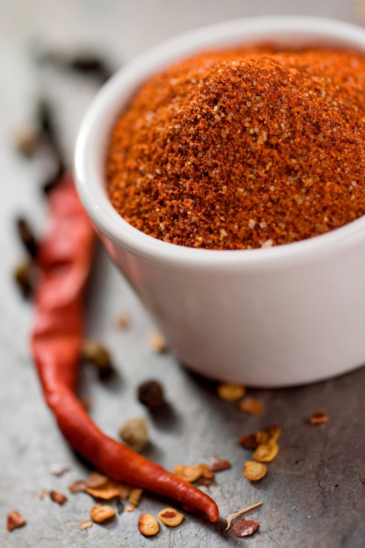 "Handmade spice rub.  Made from smoky dried anaheims, red chilies, white pepper, dry smoked sugar and a few other delicious ingredients.  You can rub it on dry or use it as an ingredient for a zesty marinade.  Shallow dof."
