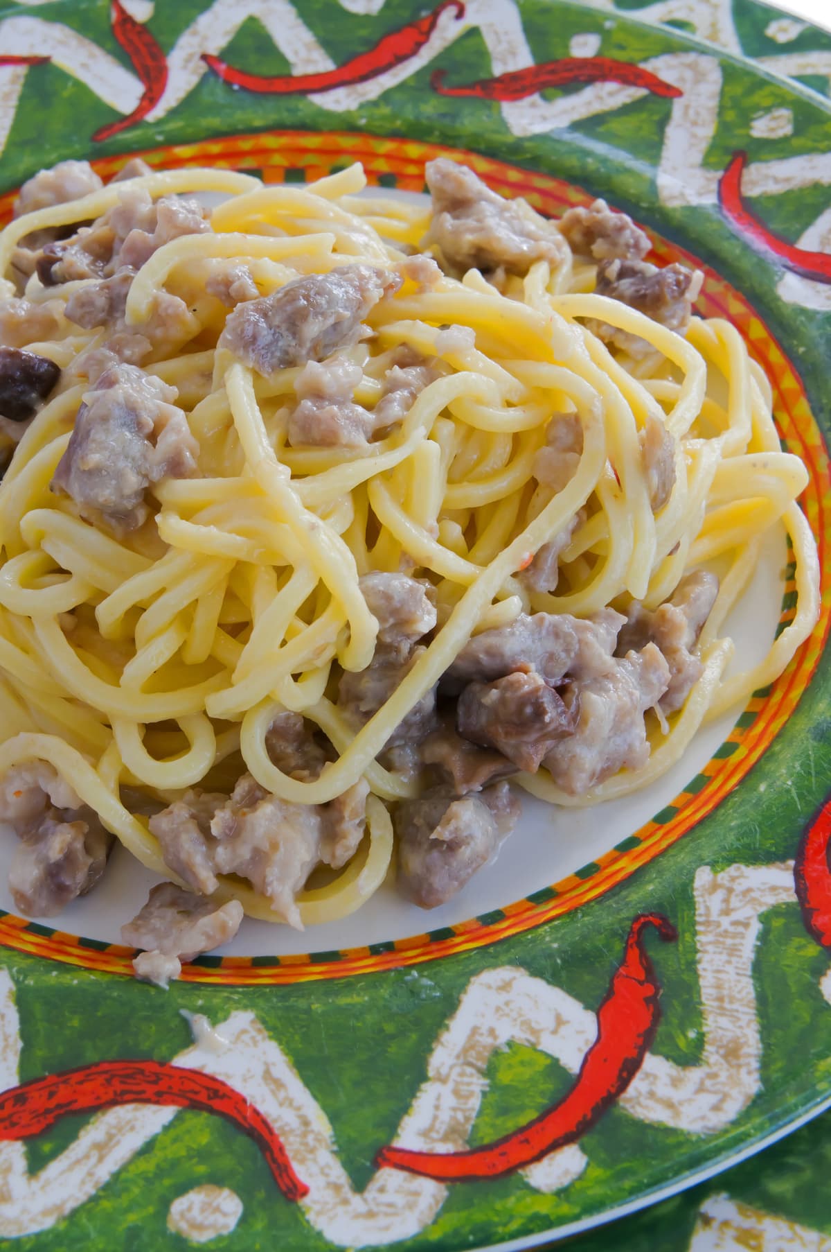 Homemade tonnarelli pasta with sausage sauce