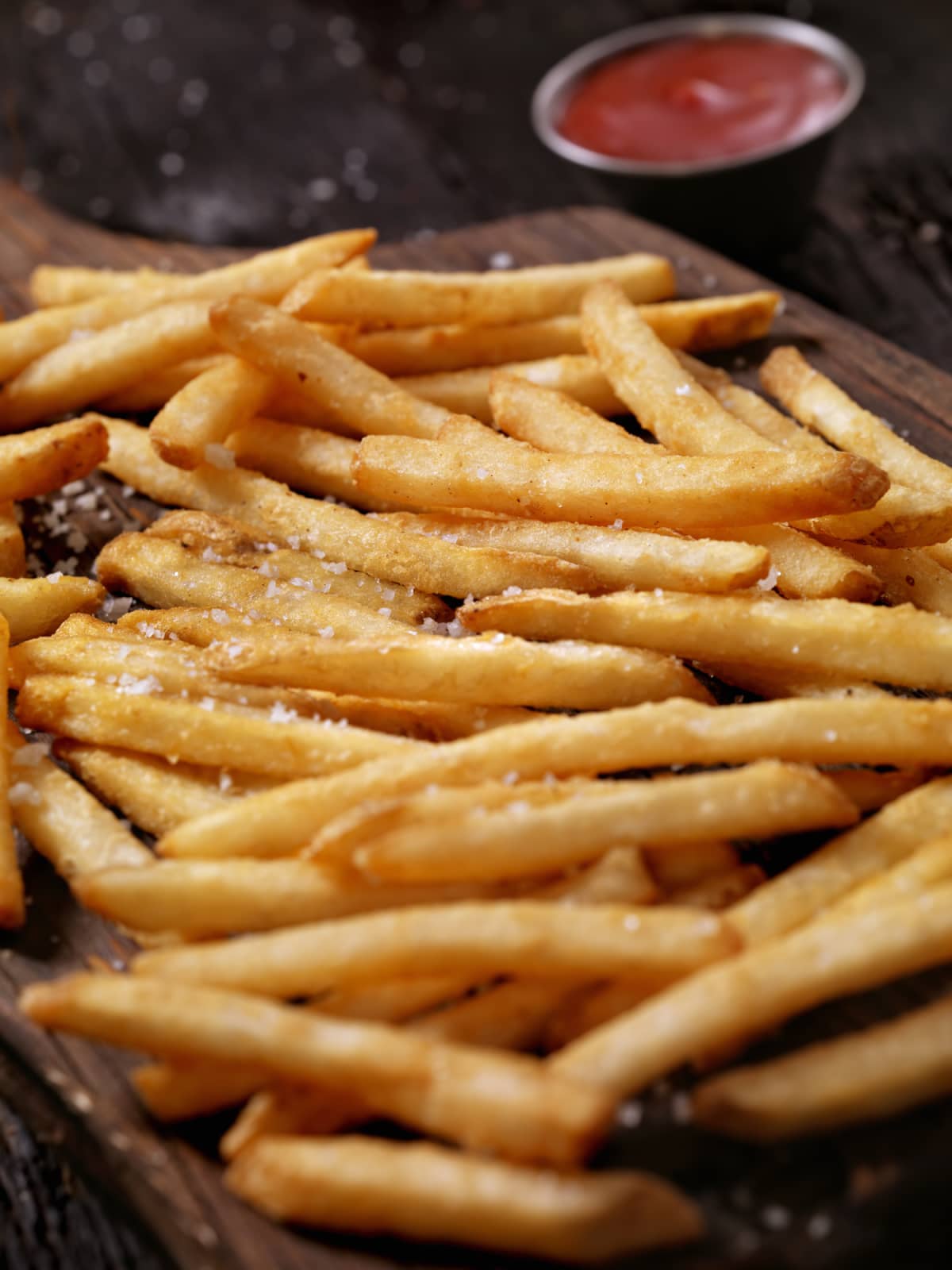 Salted french fries on cutting board