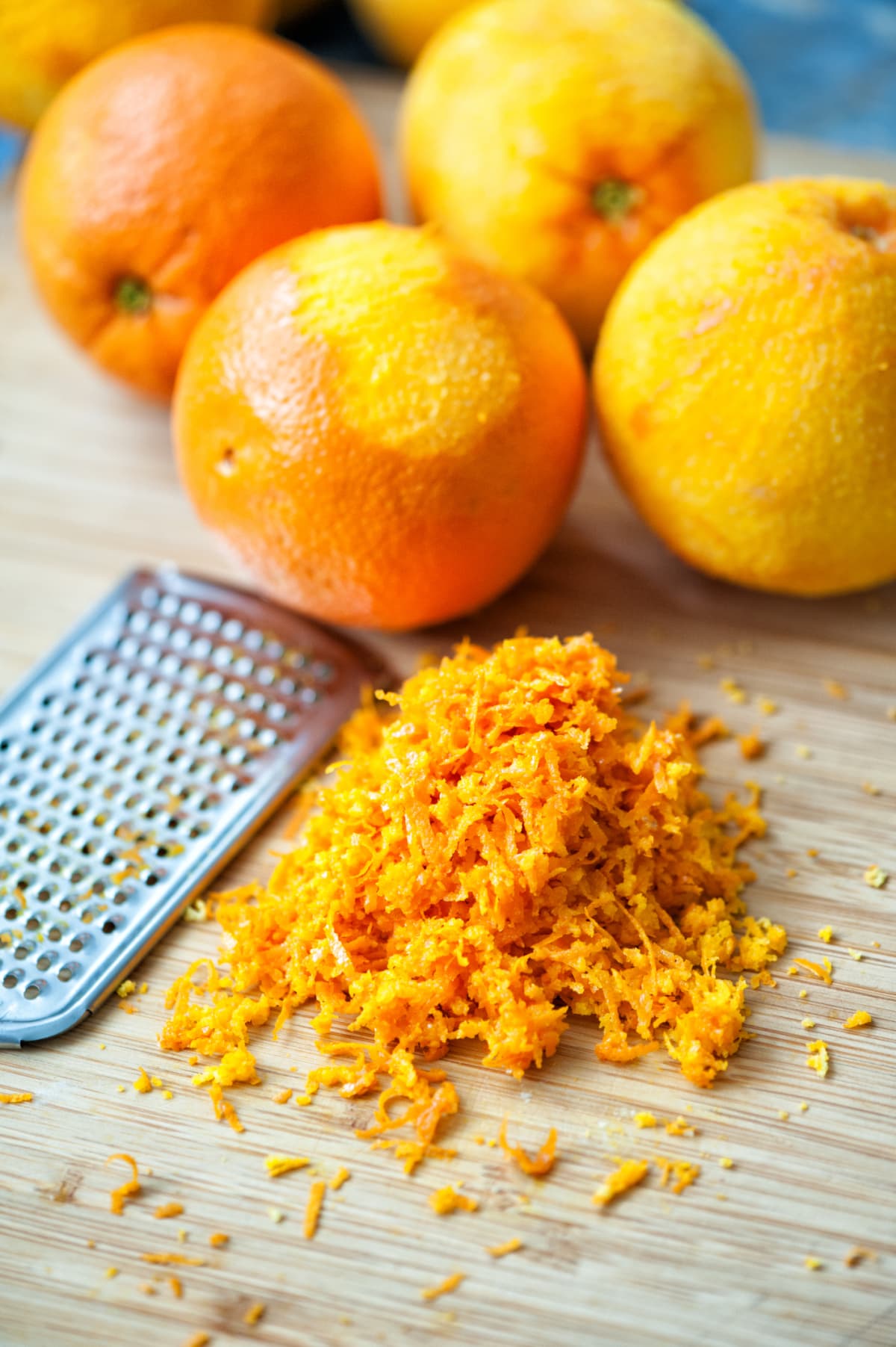 Grater peel and orange and lemon zest on the wooden table