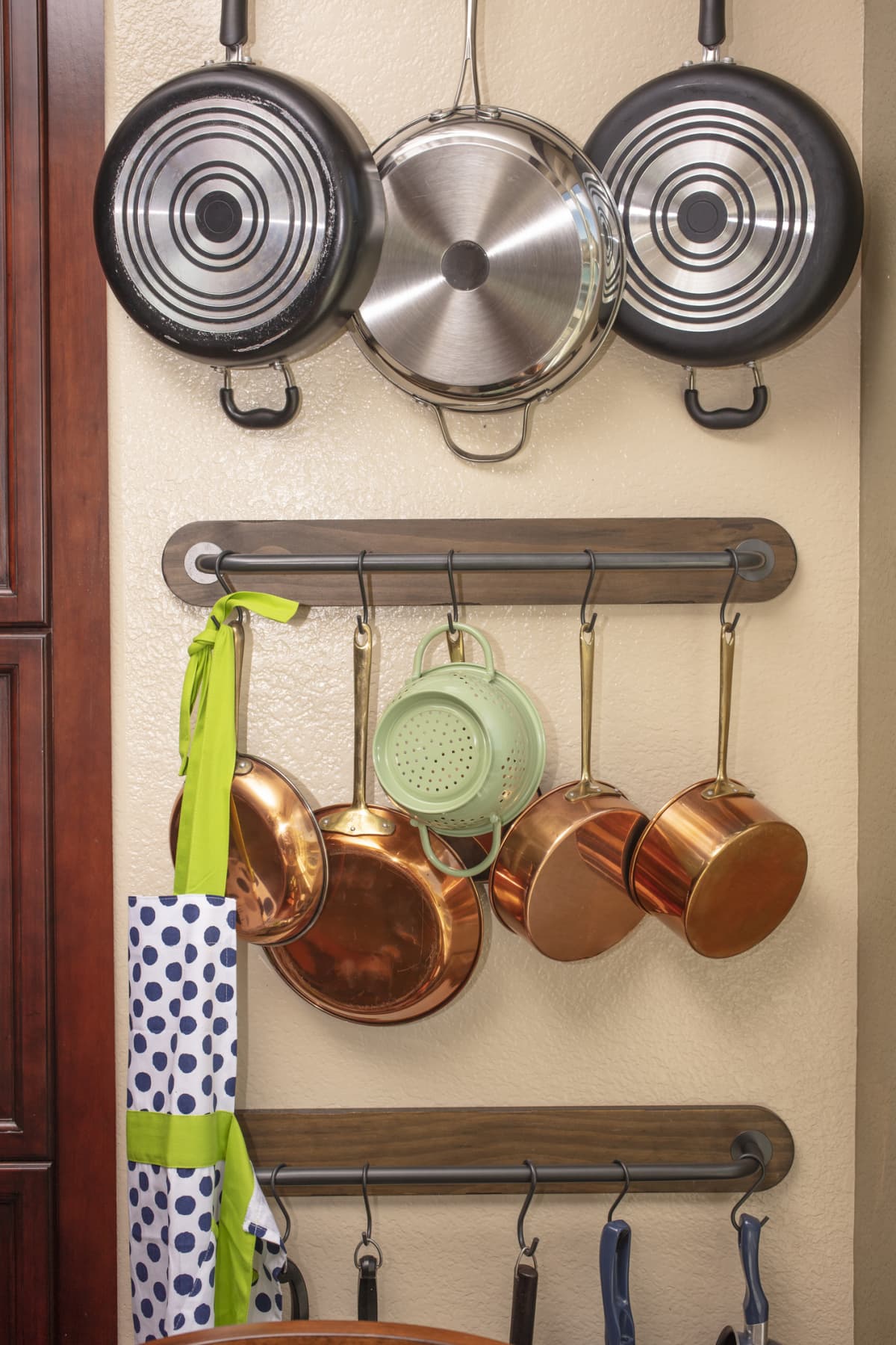 Pots and pans hanging on a kitchen wall to save space