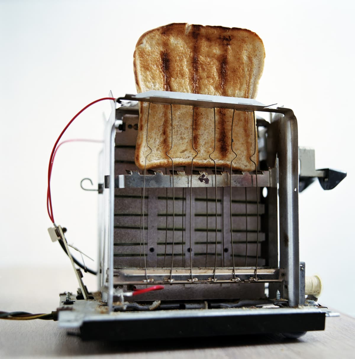 Slice of toast inside stripped-down toaster
