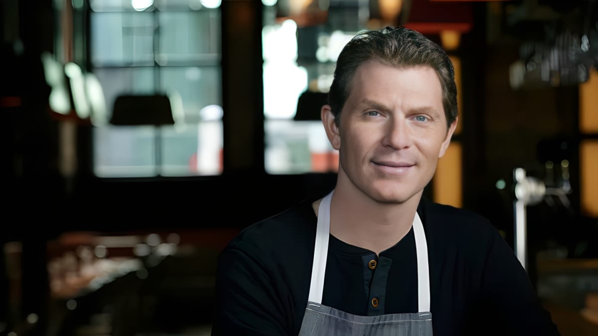 Bobby Flay in an apron smiling