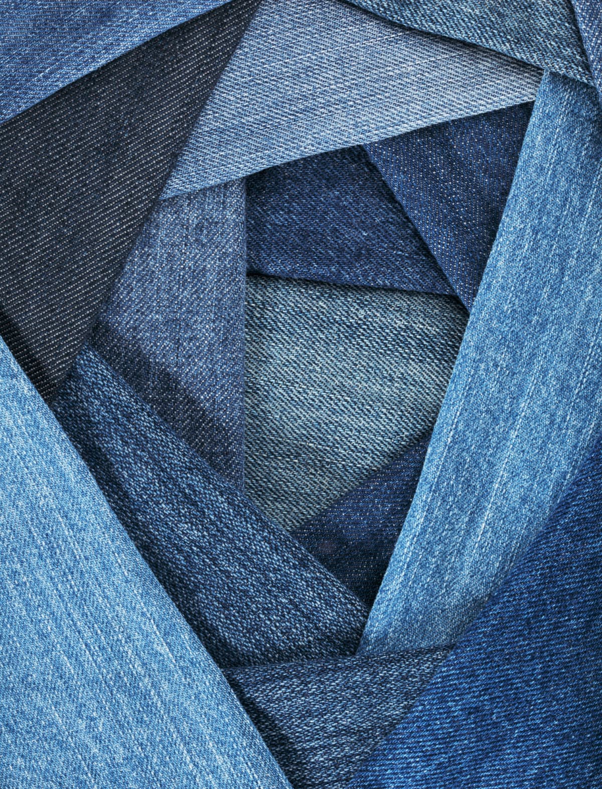 Close up of different colored denims overlapping