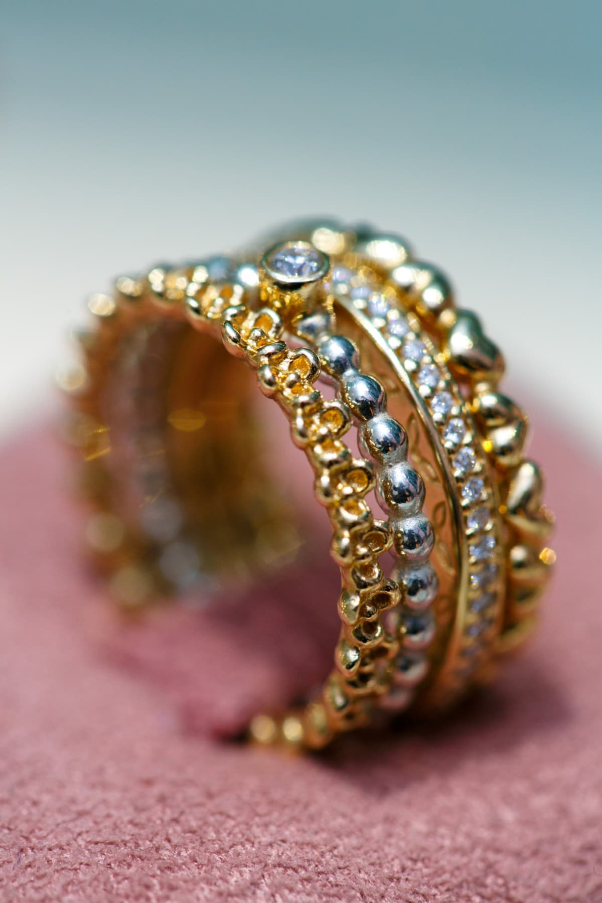 Stack of four dainty rings in gold and silver