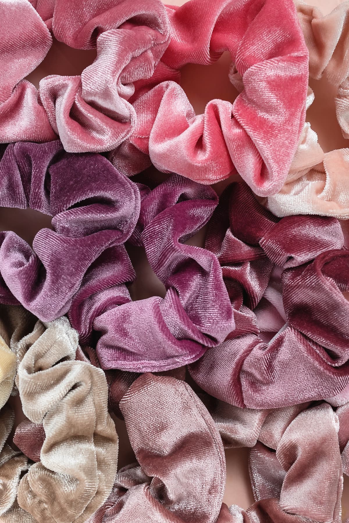 Several velour scrunchies in different colors
