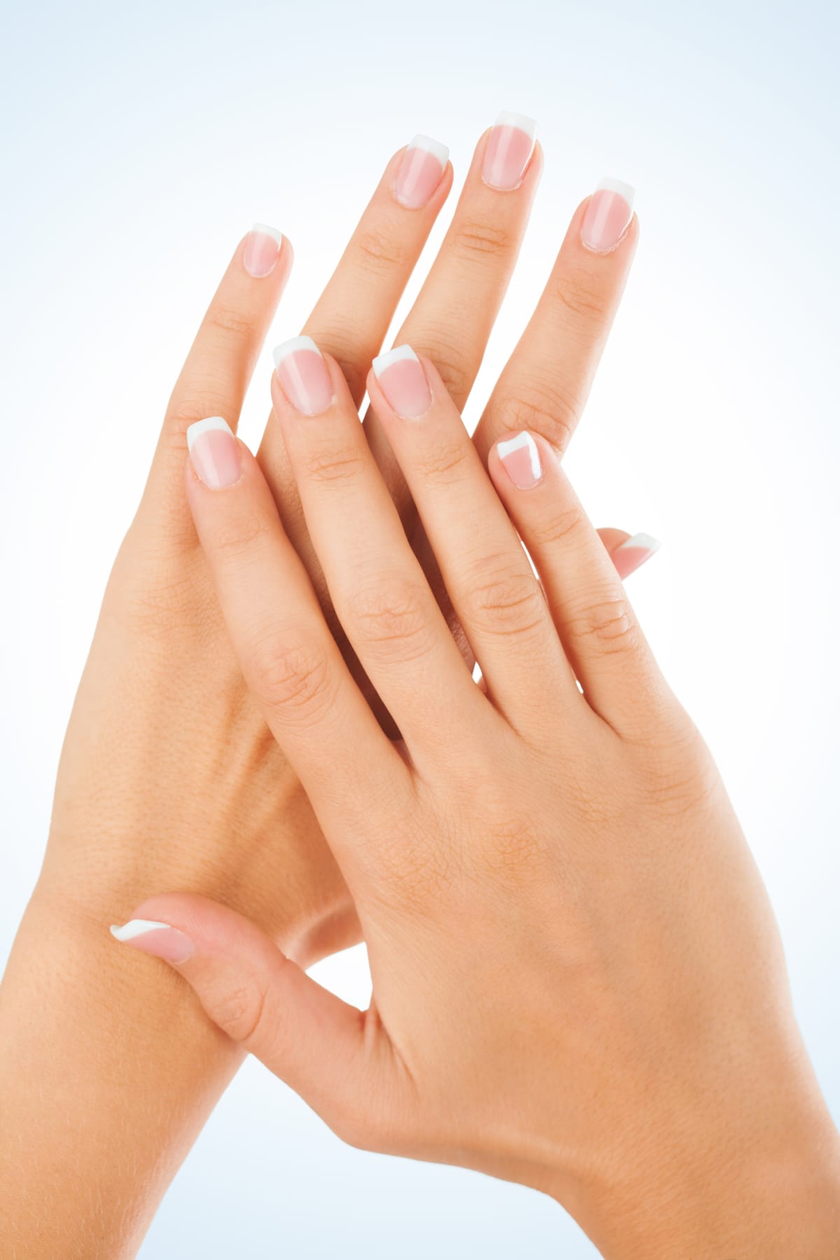 Set of nicely manicured fingernails with french manicure over white background.