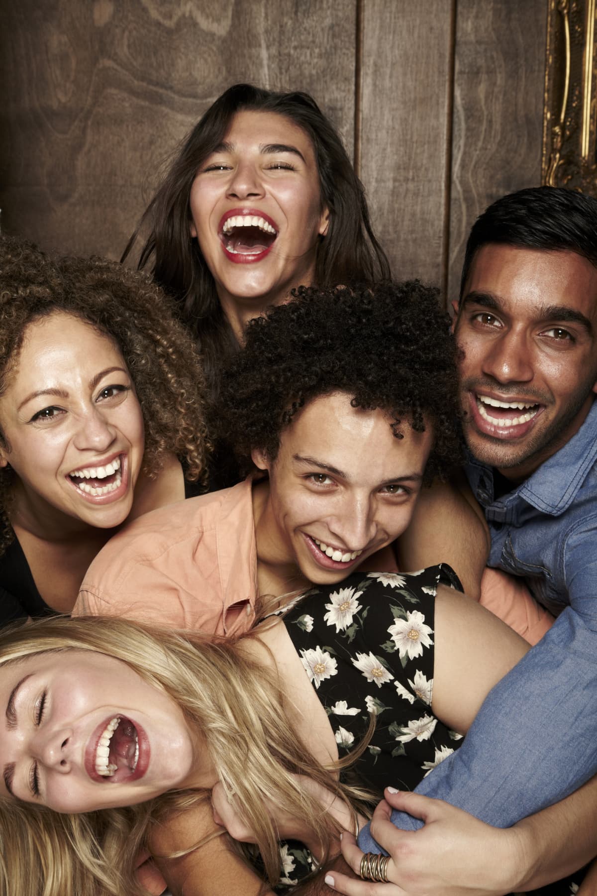 Group of people laughing while posing for a crowded selfie