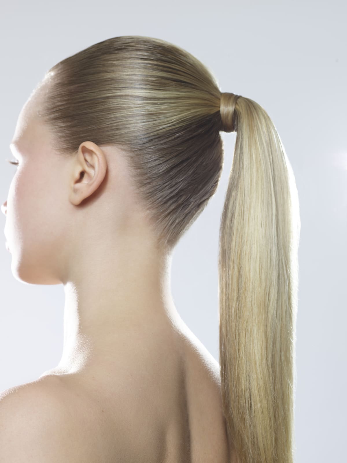 Side view of a woman with a sleek ponytail