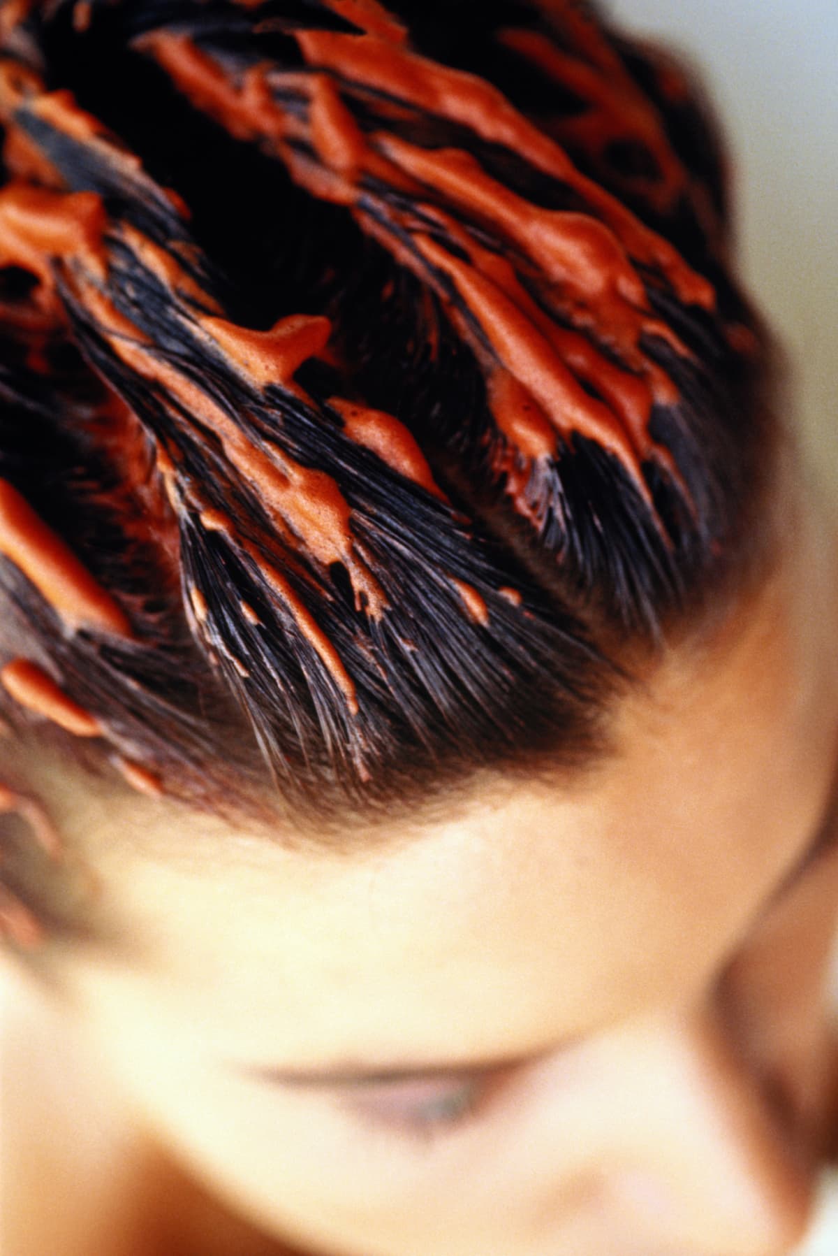 Woman with red hair dye in her hair