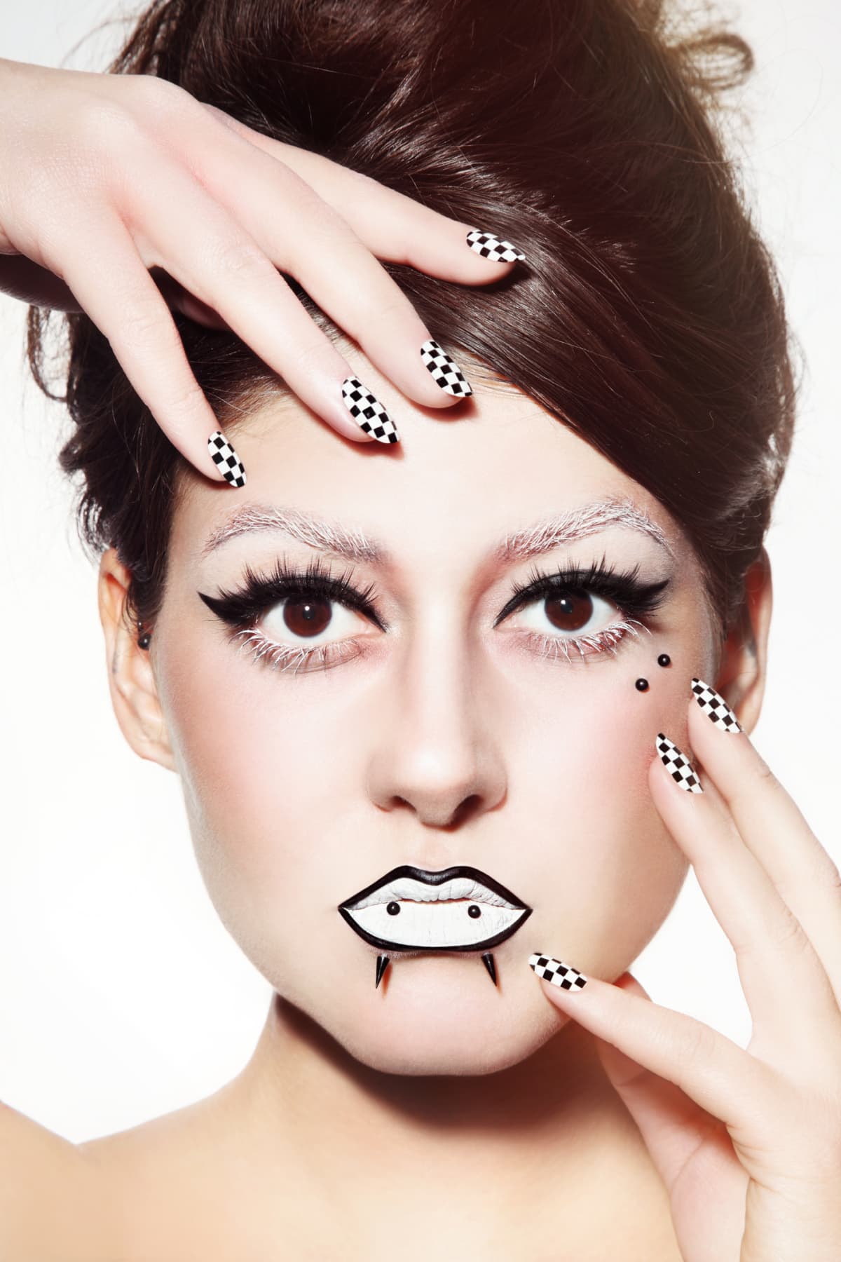 model with checkerboard nails and retro makeup