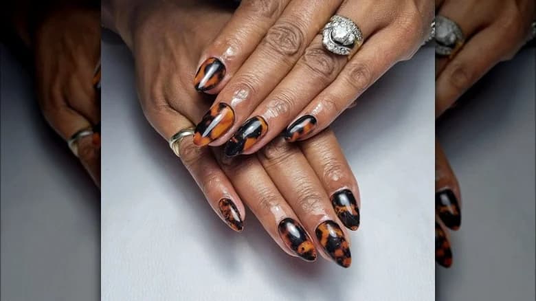 Woman's hands with a tortoiseshell pattern manicure