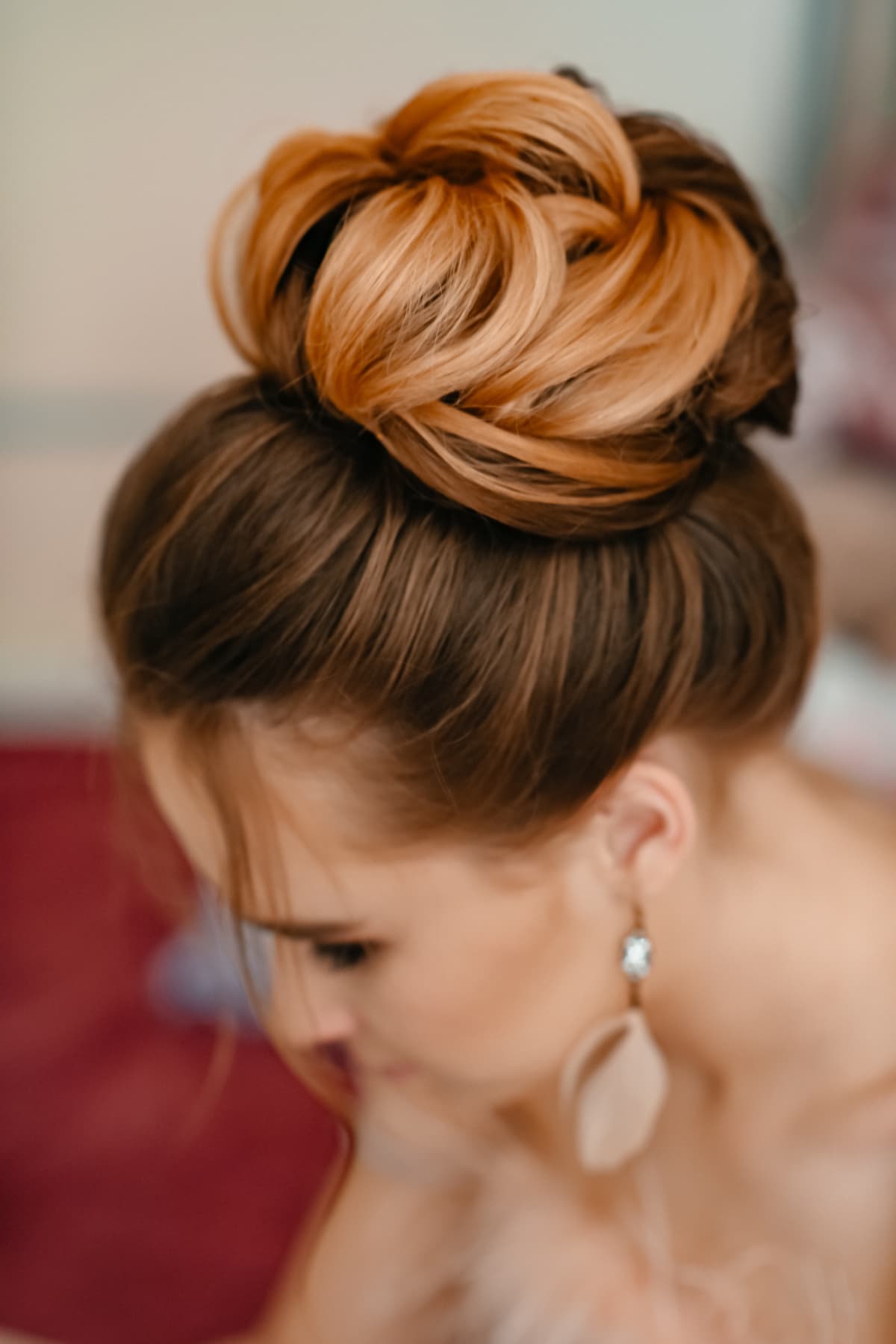 Top view of a young woman with a ballerina style inspired bun on top of her head