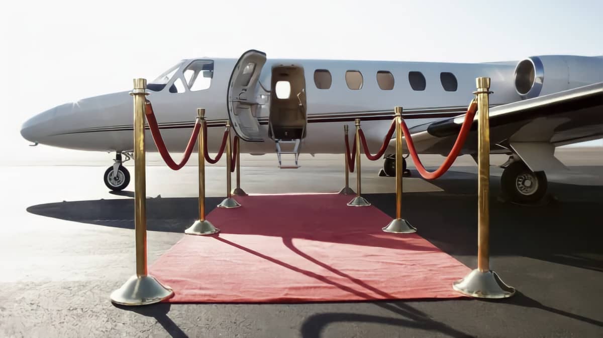 Red carpet leading to jet