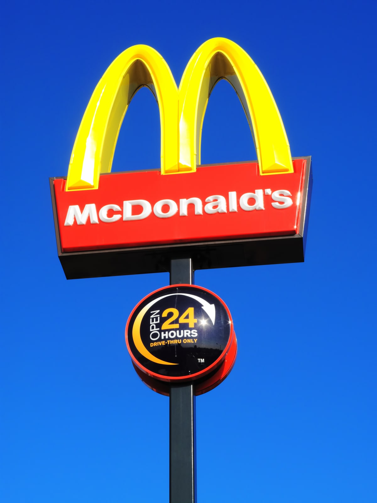 A McDonald's sign against a blue sky.