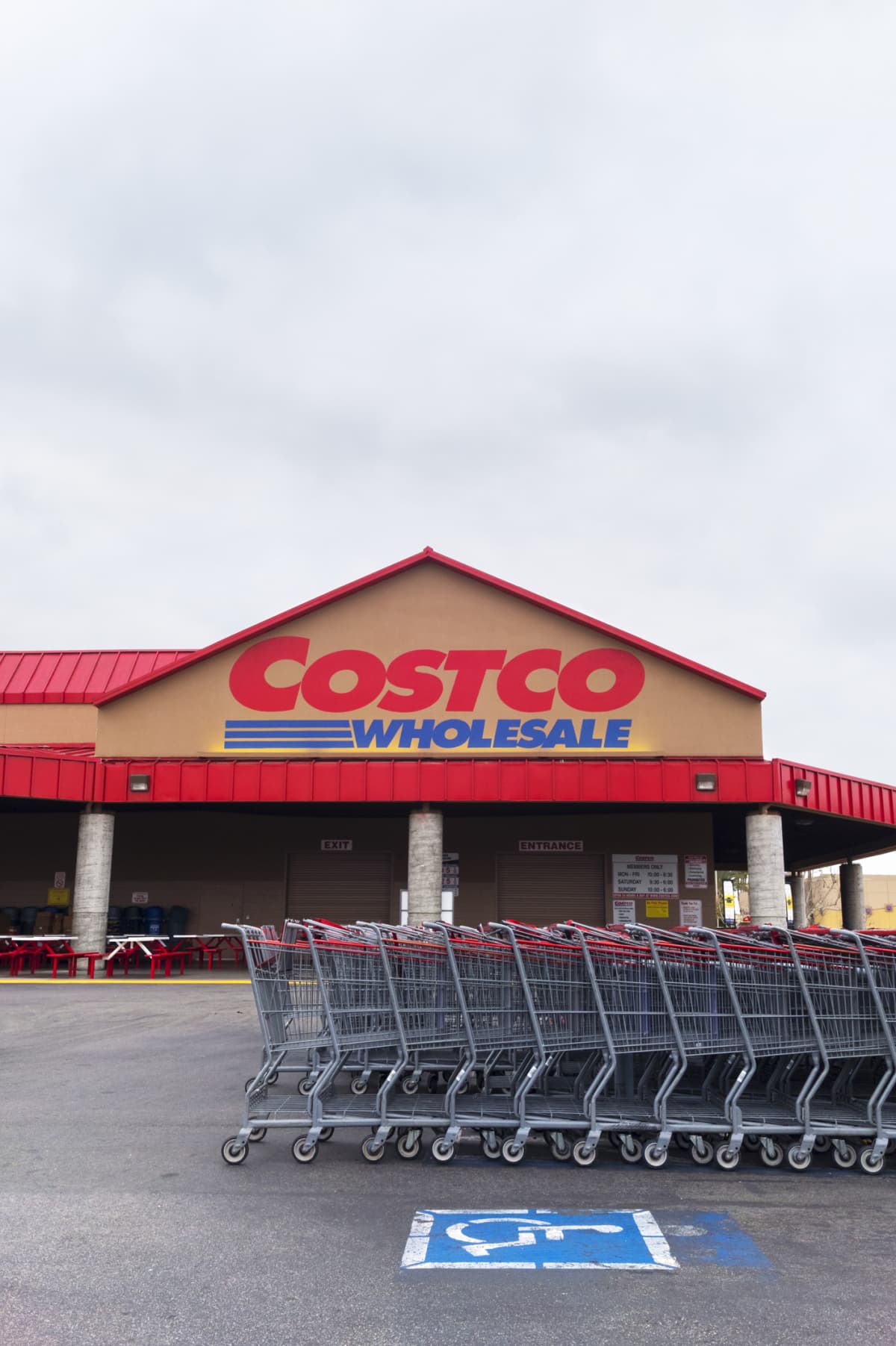 A Costco storefront with shopping carts in front of it