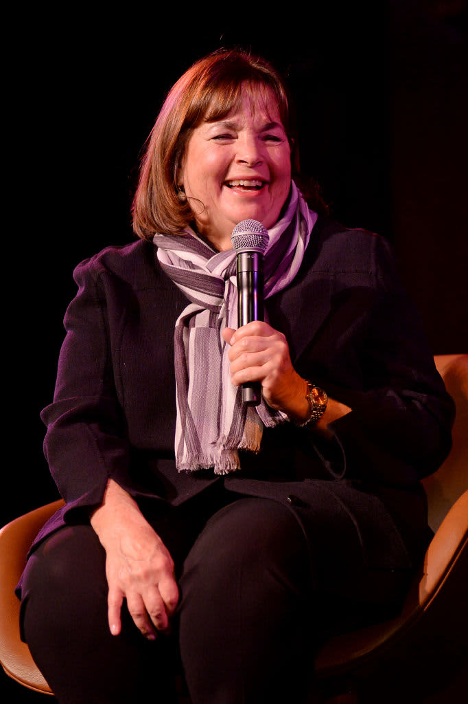 Ina Garten laughing while holding a microphone.
