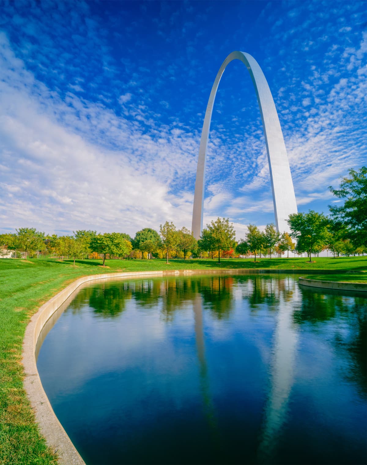 Saint Louis, United States: June 12, 2018: Gateway Arch Reflects in Pond in morning light