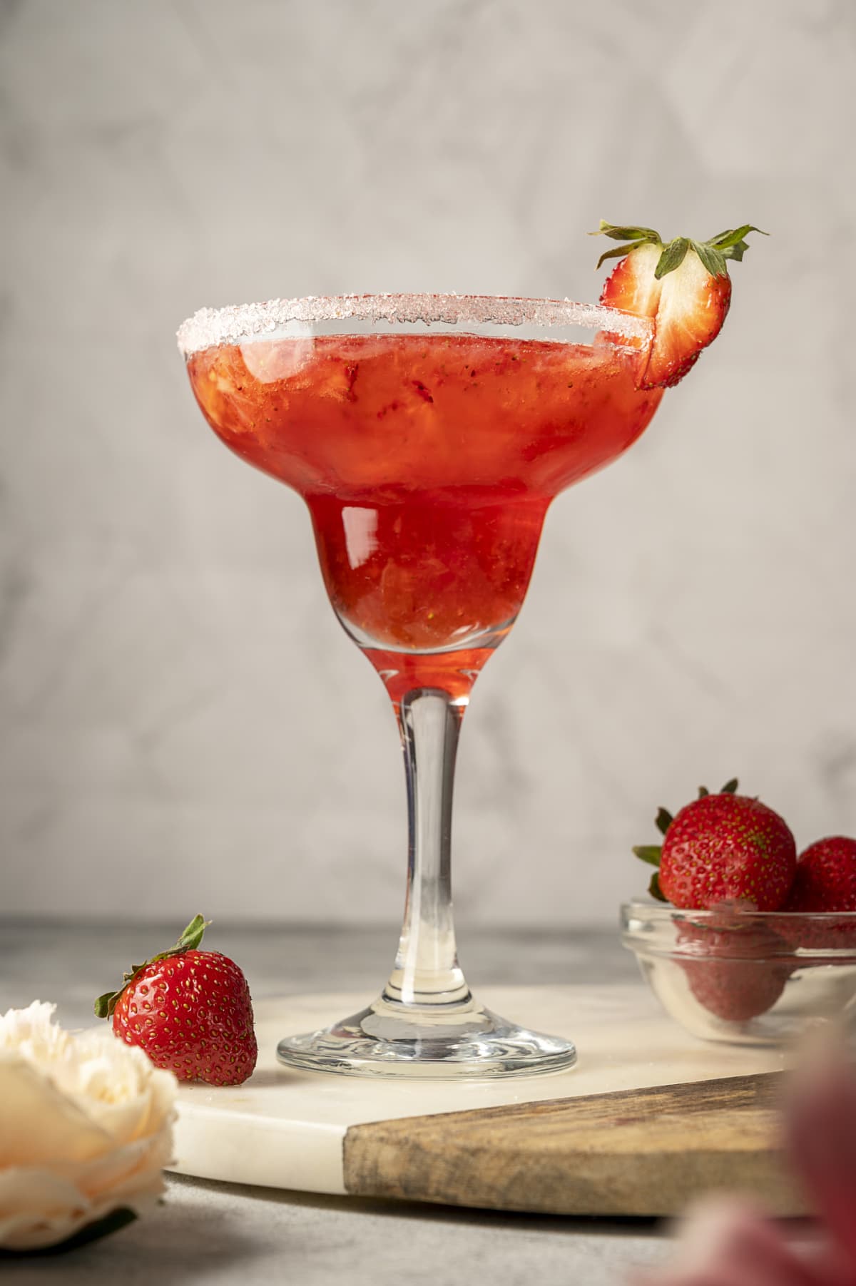 Strawberry refreshing margarita in tall footed glasse with fresh strawberries