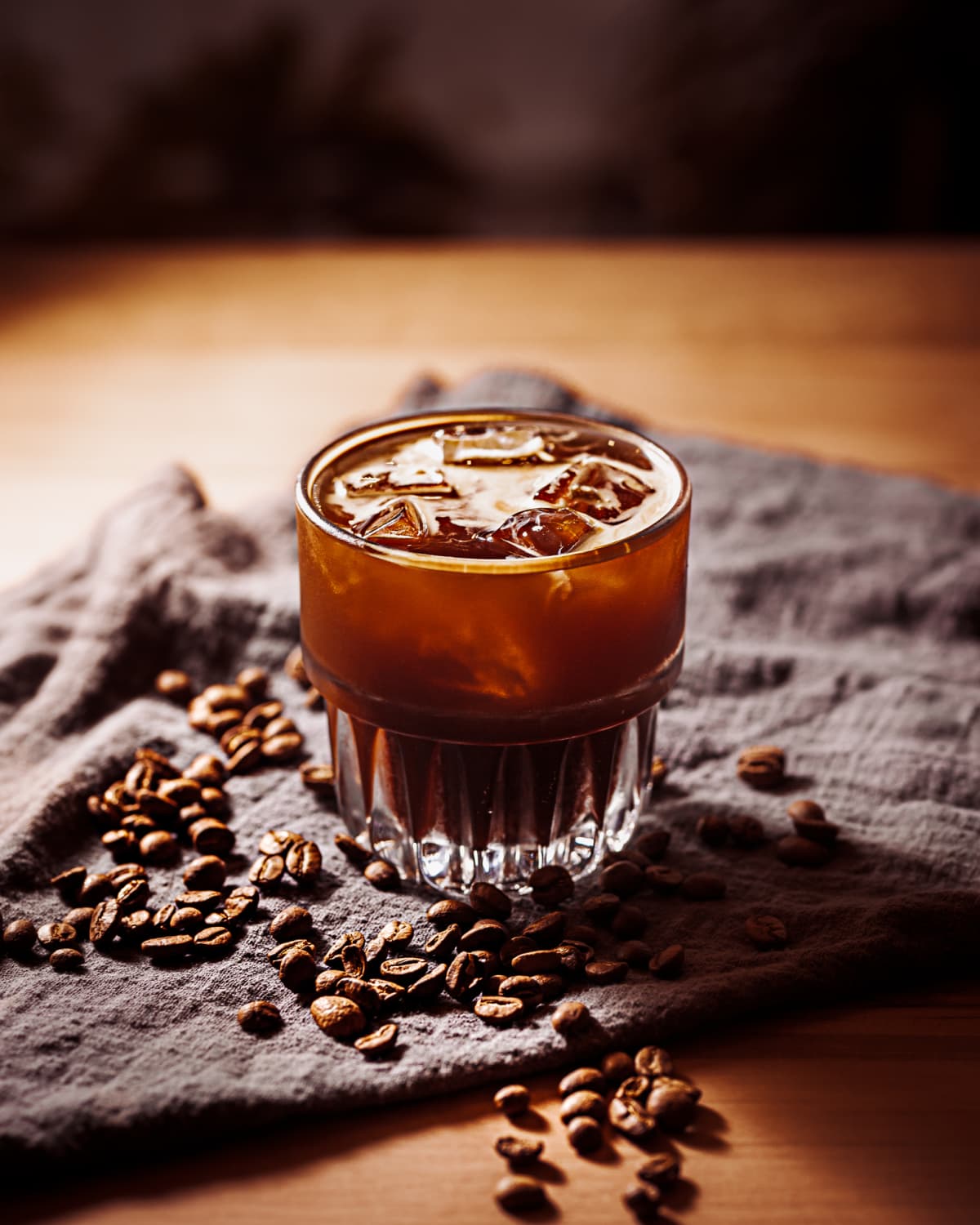 Cold Brew Coffee with roasted coffee bean, wooden board