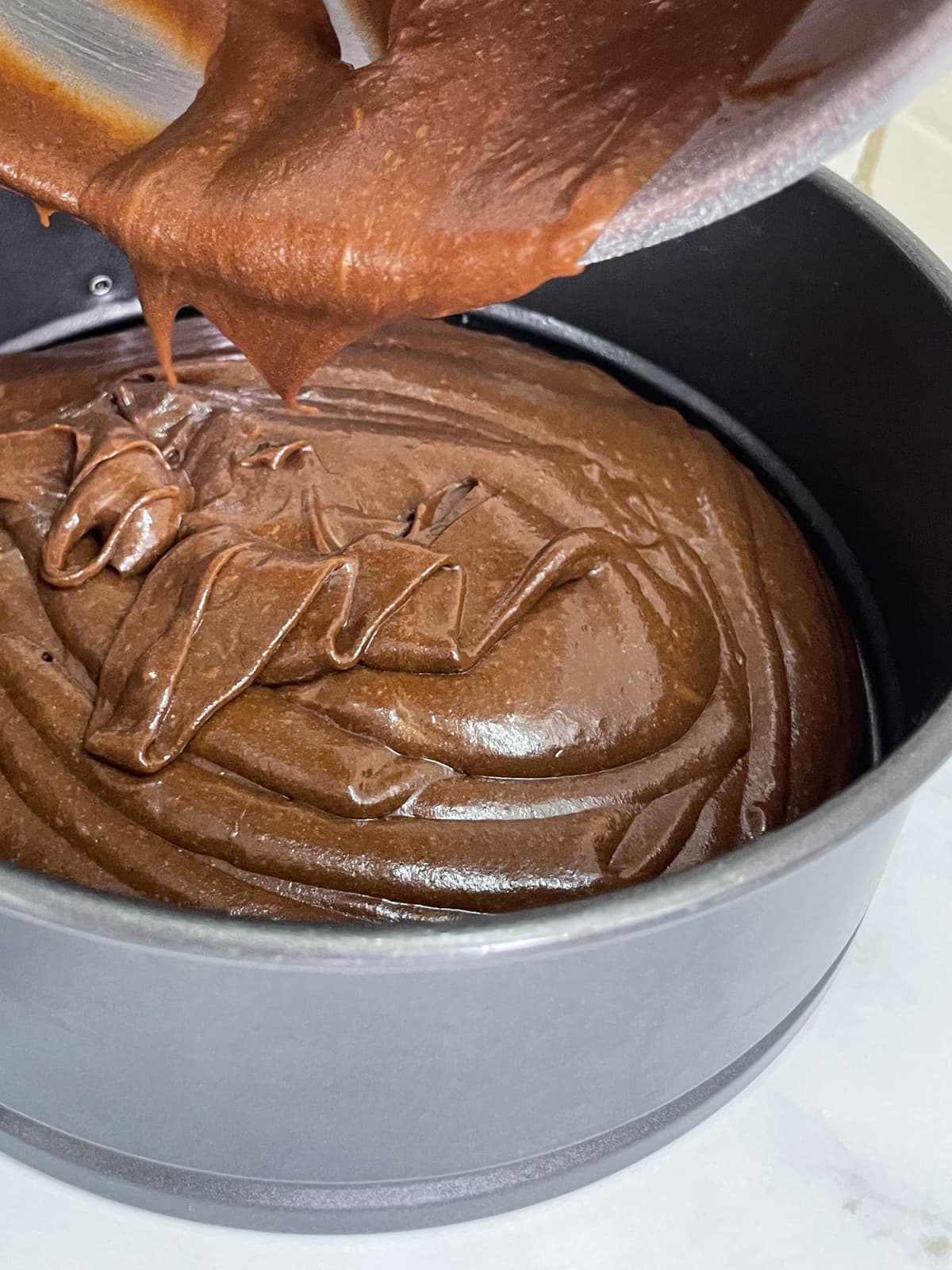 Stock photo showing close-up view of a chocolate sponge cake being made.