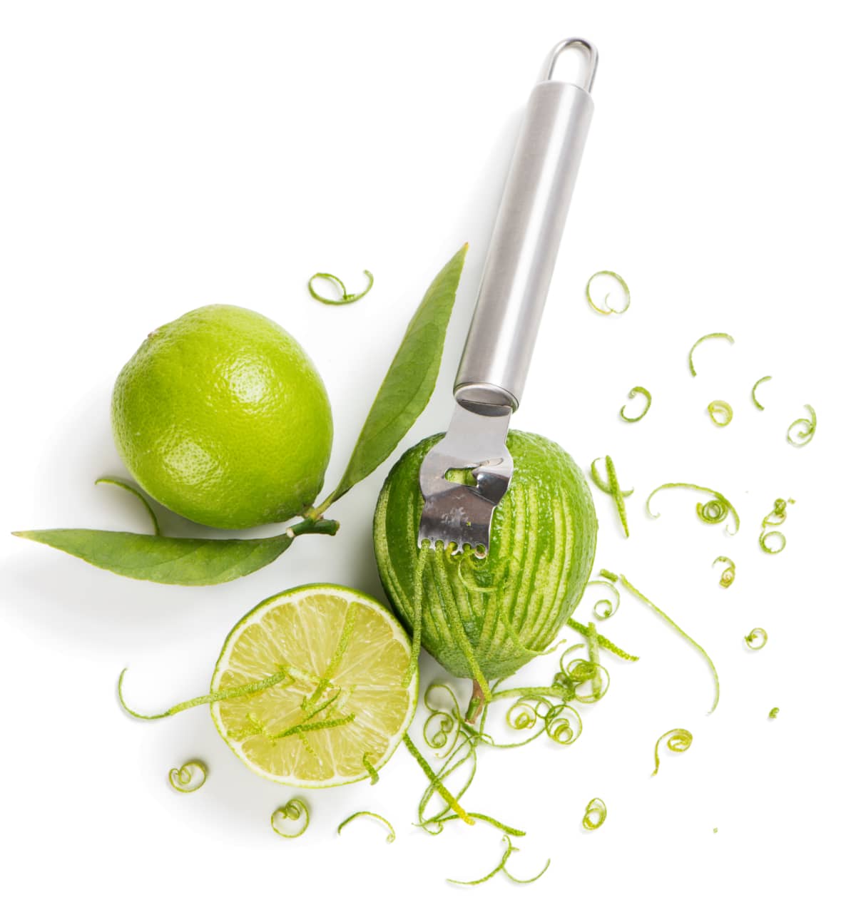 Zesting limes on white background