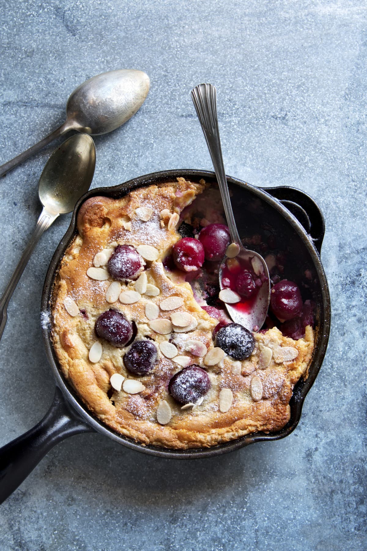Cherries clafoutis with a spoon.