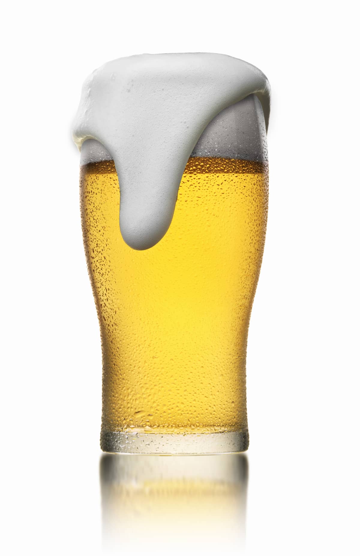 Chilled glass of beer against a white background