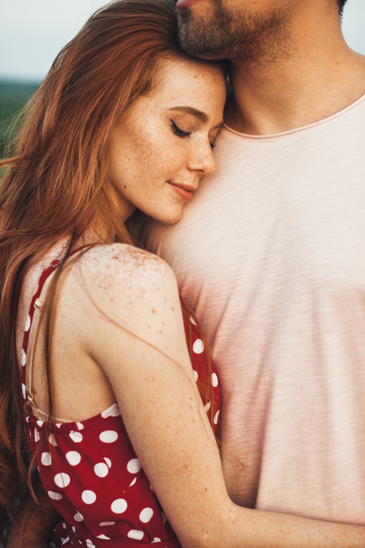 smiling woman leaning into man's chest