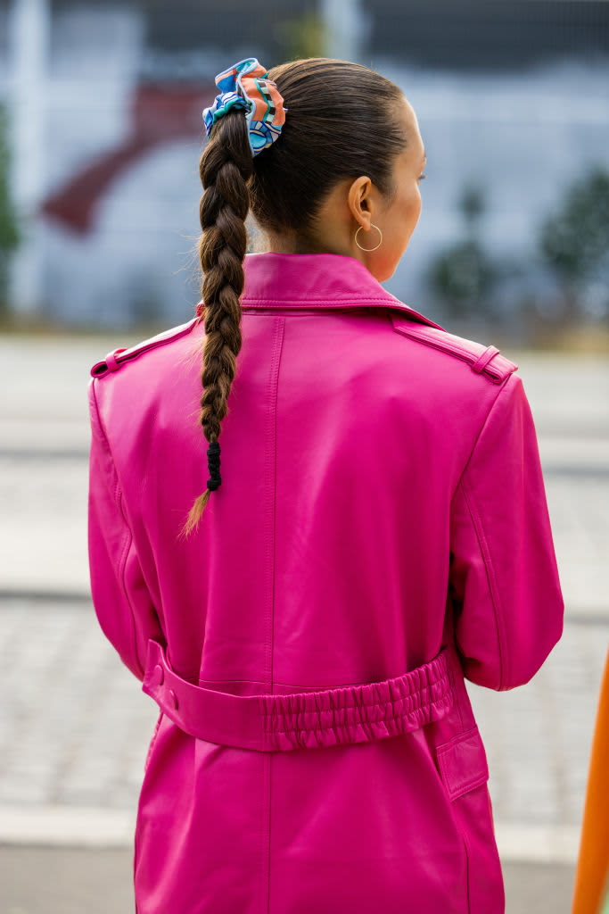 woman with long braid held in scrunchie