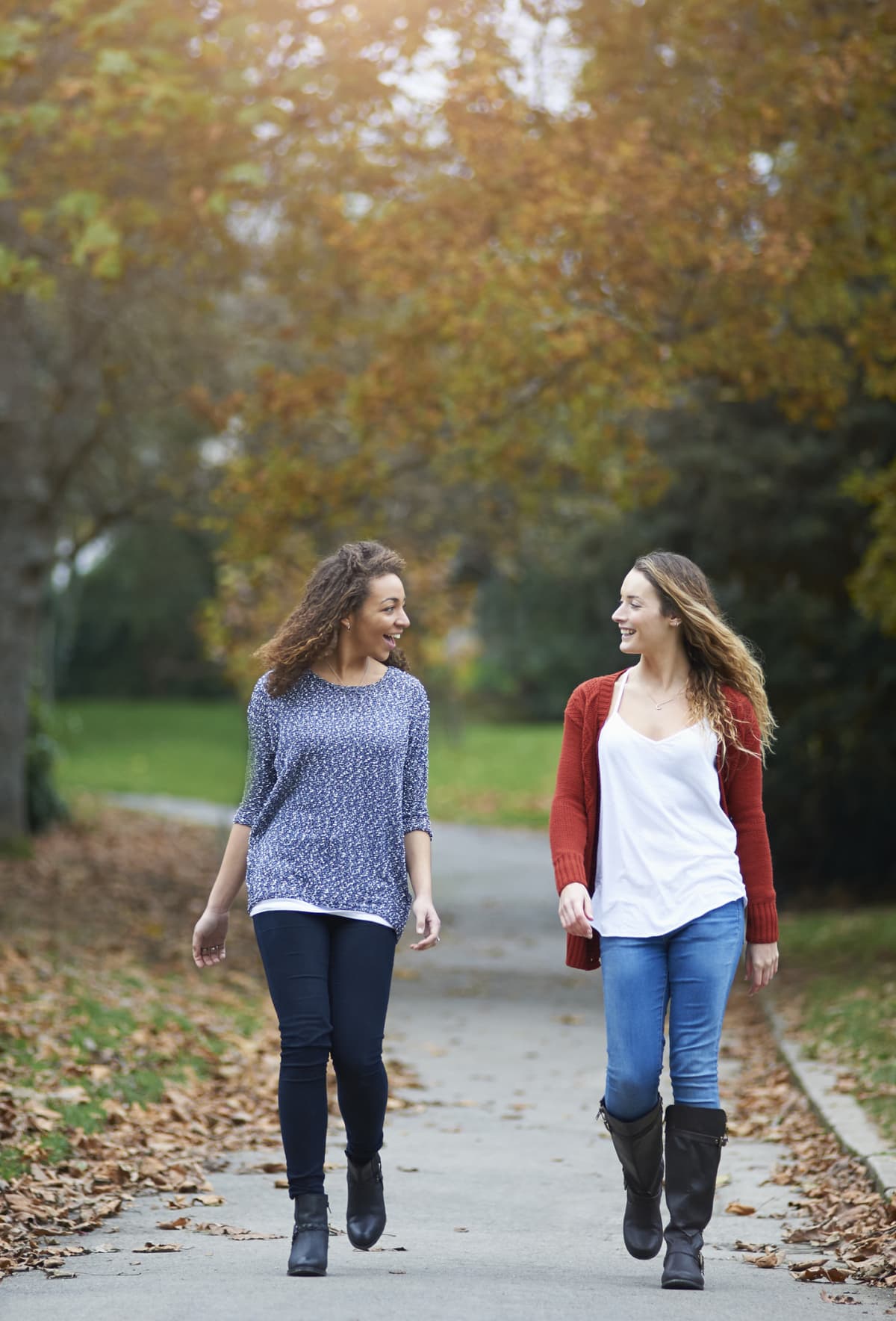 two women walking in park