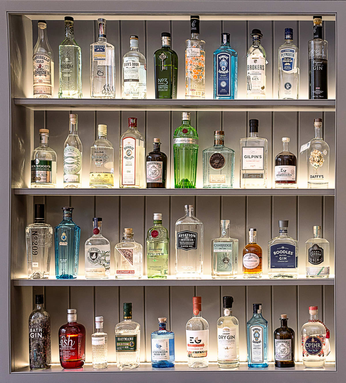 A collection of perfectly positioned gin bottles in four rows