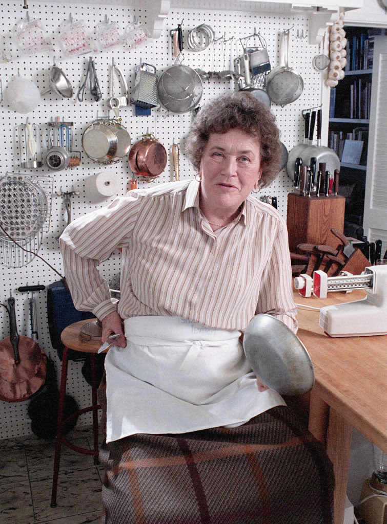 circa 1965:  American chef Julia Child stands in front of a countertop, holding a whisk and a ladle by a mixing bowl, possibly on the set of her television series, 'The French Chef'.  (Photo by New York Times Co./Getty Images)