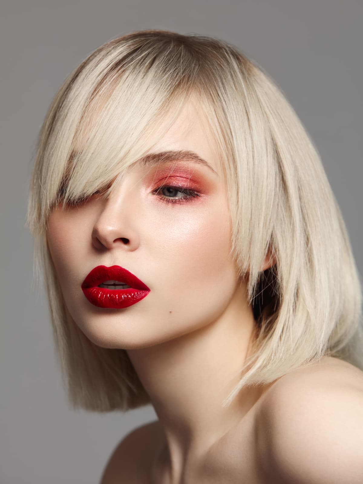 Studio portrait of beautiful woman with bright professional make-up and bob haircut