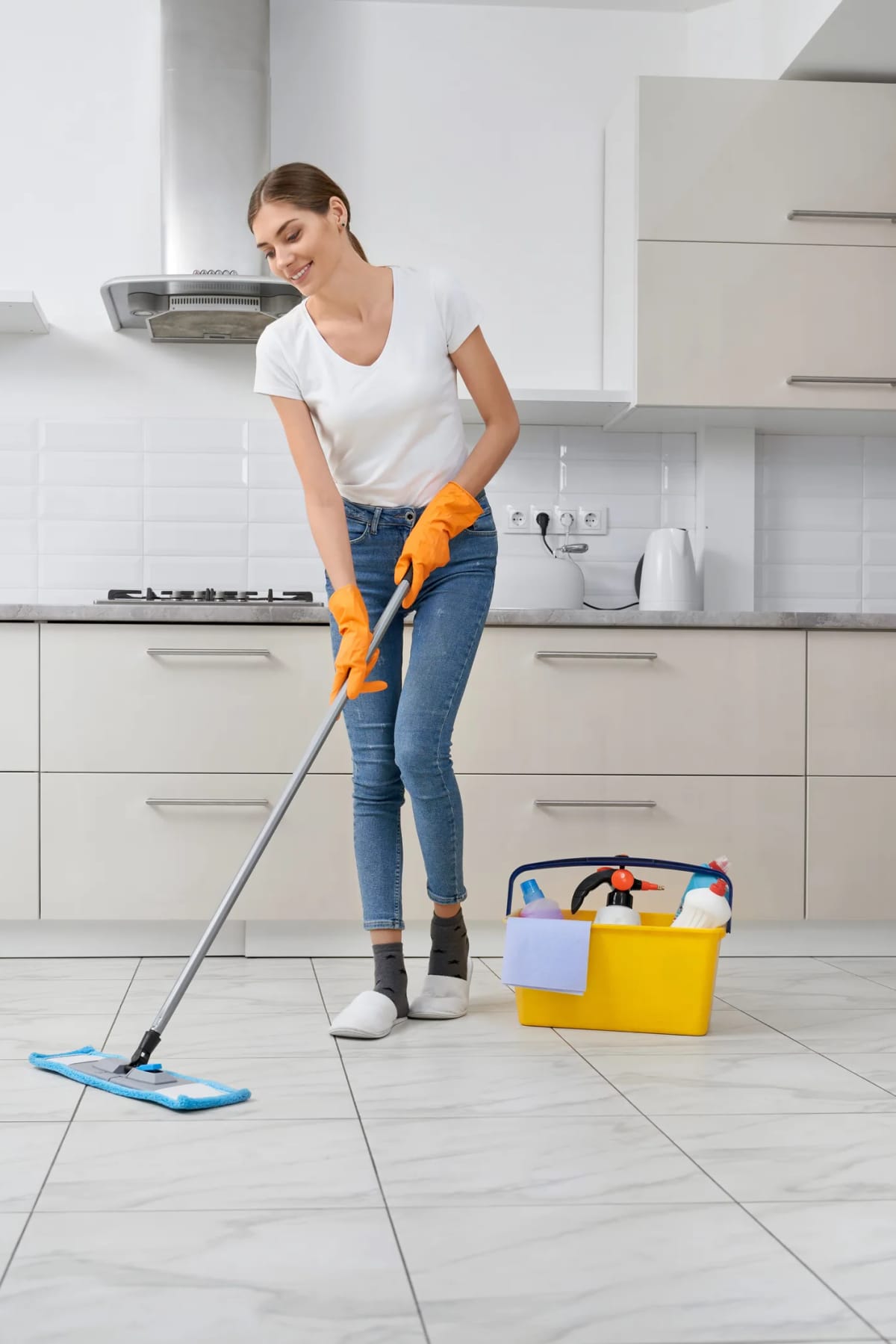 A woman mopping the kitchen floor