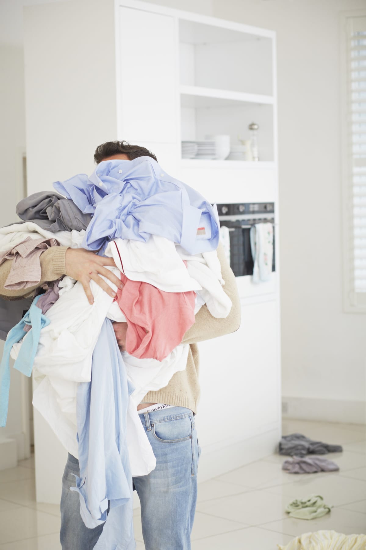 Person holding pile of clothes