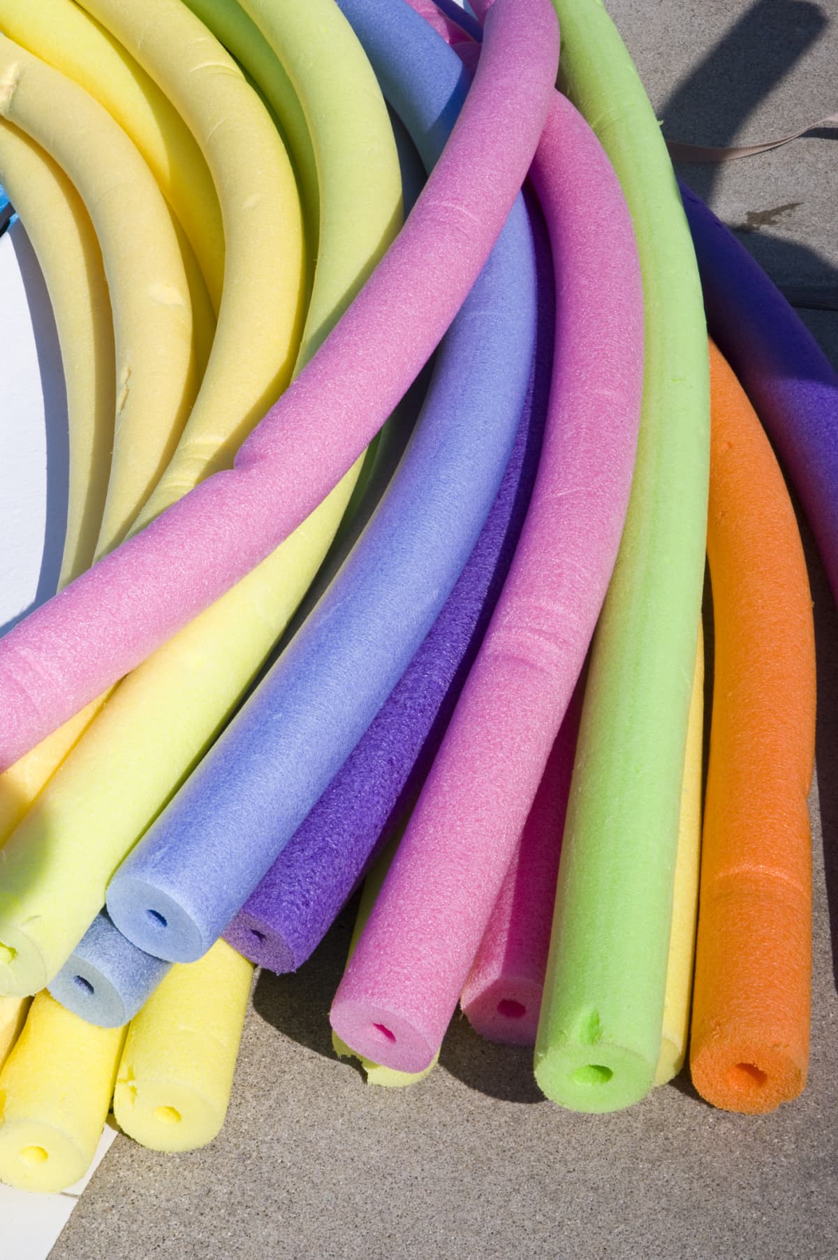 Multicolored swimming pool noodles.