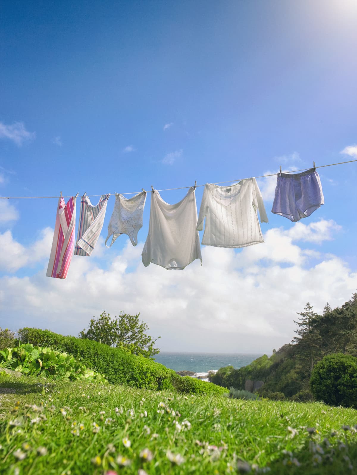 Clothes hanging on outdoor clothesline during sunny day