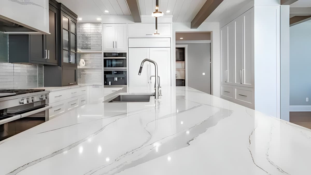 White-colored modern kitchen with stainless steel appliances and white countertop