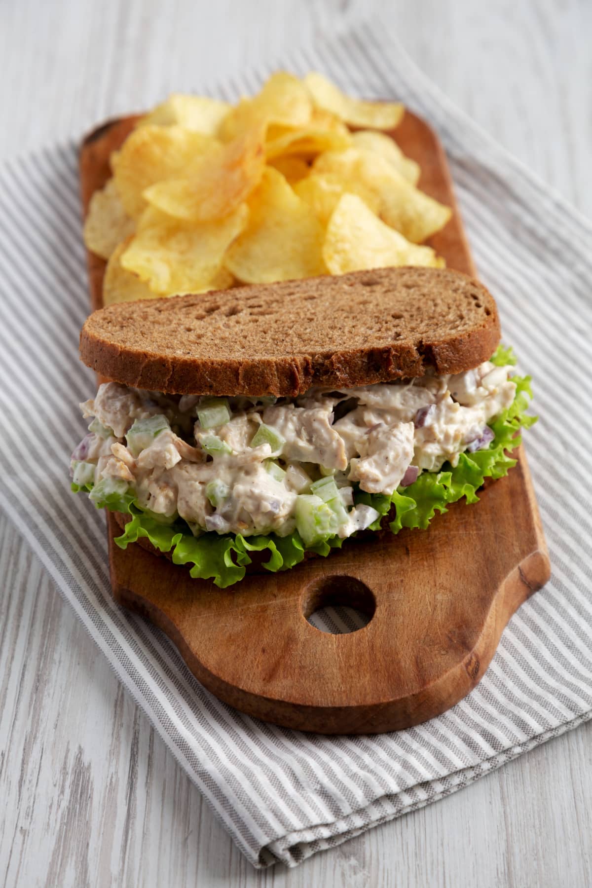 Homemade chicken salad sandwich with potato chips