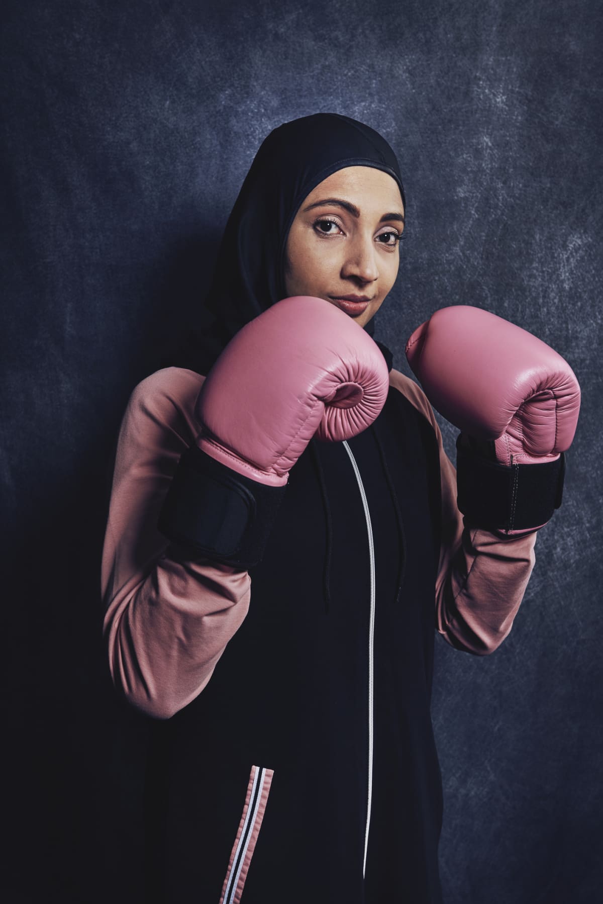 Woman wearing pink boxing gloves