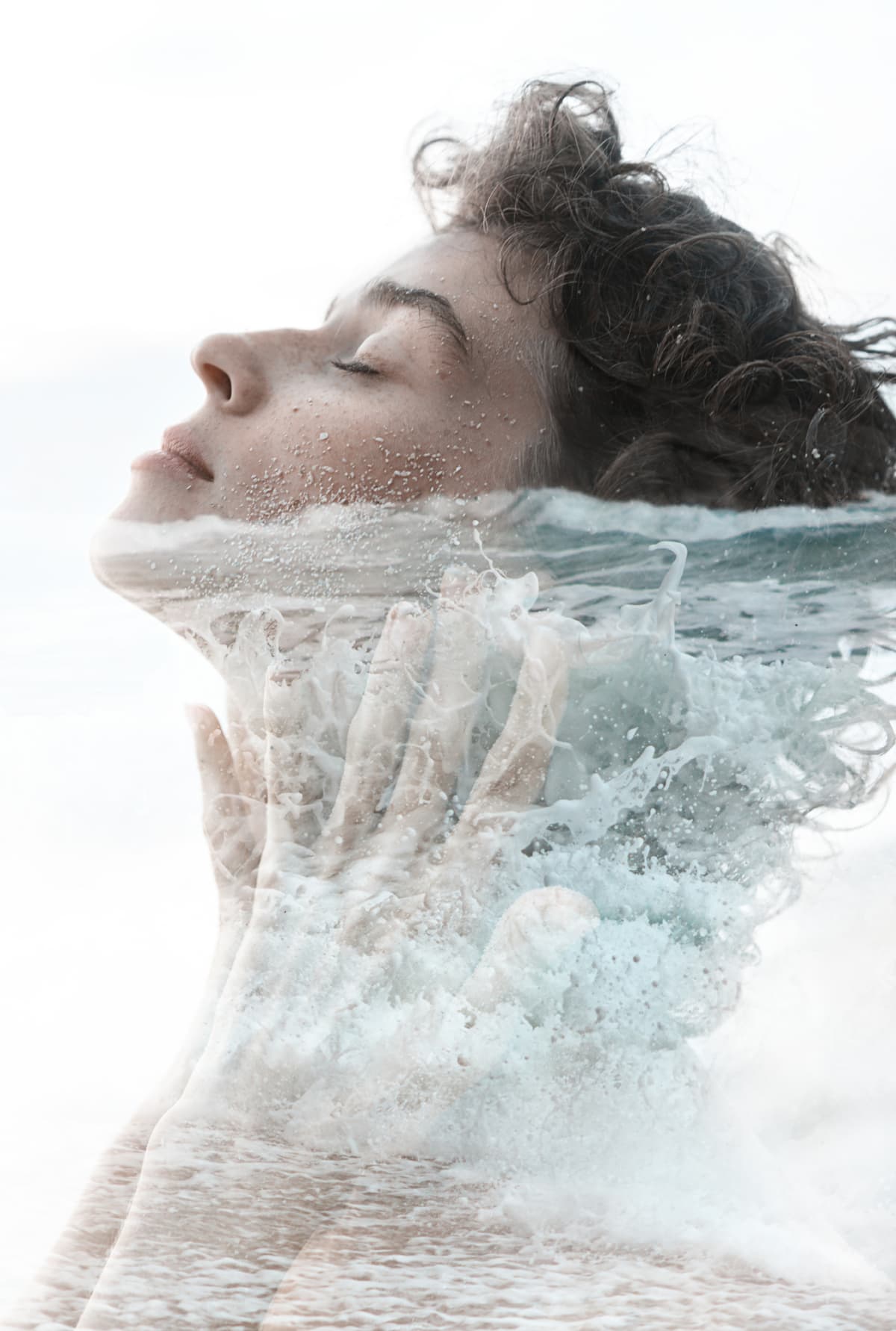 Double exposure of young woman almost completely submerged in water