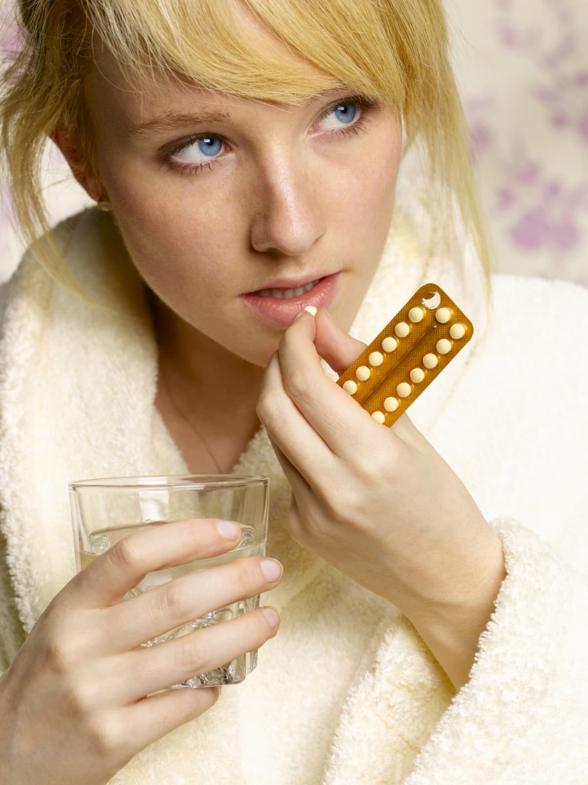 Woman taking a birth control pill as her form of contraception