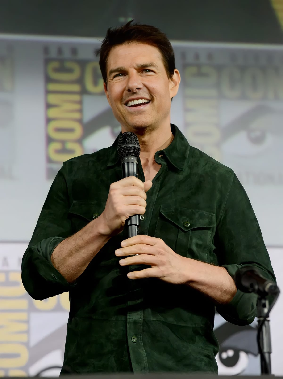 Tom Cruise speaking with a microphone at ComicCon
