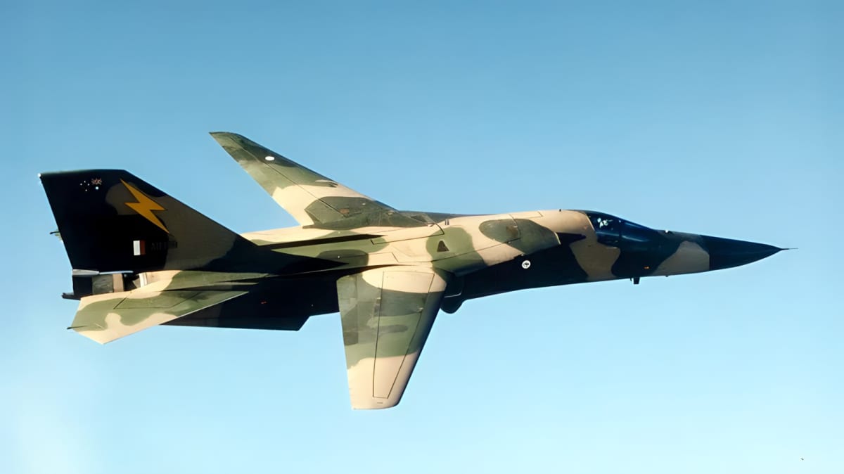 Green and brown camo F-111 flying