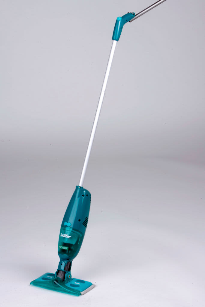 Green Swiffer mop against a white background