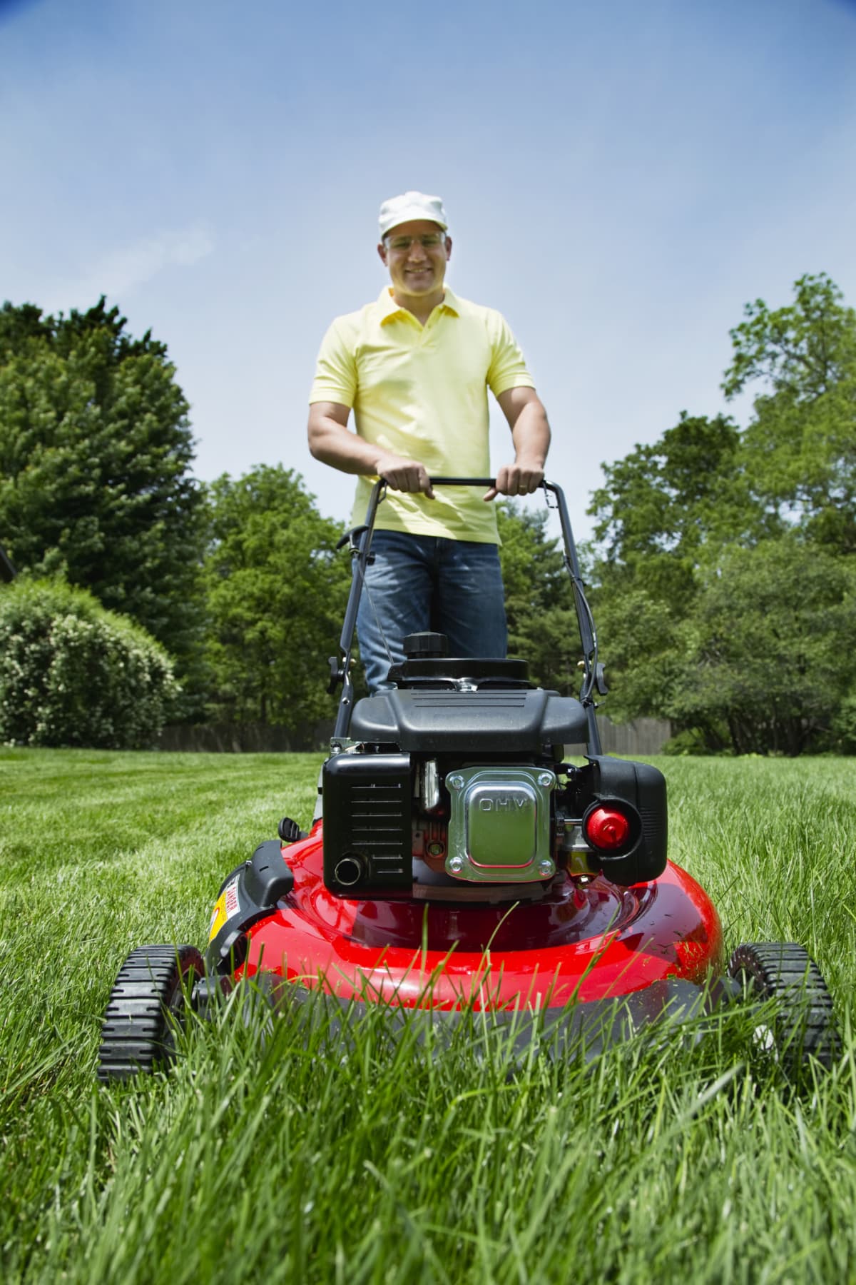 Man mowing his lawn with push mower